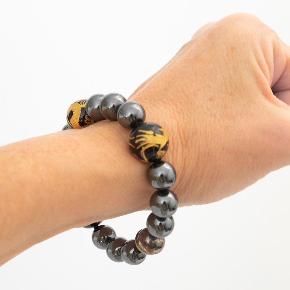 Hematite bracelet with onyx gold leaf interspersed dragon beads magnetic closure